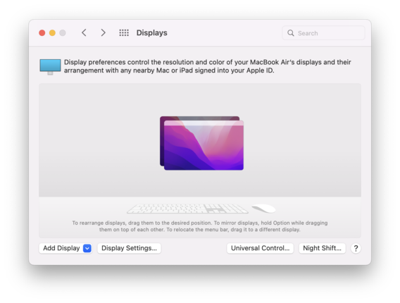 A window of the "Displays" setting on MacOS. At the top of the window, it reads, "Display preference control the resolution and color of your MacBook Air's displays and their arrangement with any nearby Mac or iPad signed into your Apple ID." In the middle of the window shows a layer of two screens that looks the same.